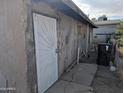 Rear exterior showing a damaged wall and door at 208 W Dr Martin Luther King Jr St, Eloy, AZ 85131