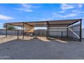 Metal-roofed animal shelter with two stalls and a storage shed at 20111 W Steed Ridge Rd, Wittmann, AZ 85361