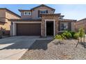 Two-story home with stone accents and a two-car garage at 23095 E Mewes Rd, Queen Creek, AZ 85142