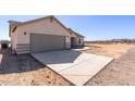 Newly constructed home with a large driveway and desert landscape at 36813 W Tonto St, Tonopah, AZ 85354