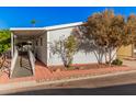 Mobile home with covered porch and access ramp,landscaped yard at 2650 W Union Hills Dr # 54, Phoenix, AZ 85027