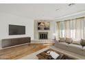 Living room featuring a brick fireplace and hardwood floors at 2544 W Knowles Ave, Mesa, AZ 85202