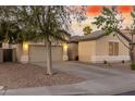 Two-car garage, neutral color exterior, and well-maintained landscaping at 1384 E Morelos St, Chandler, AZ 85225