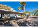 View of parking area with covered carport and surrounding landscape at 280 S Elizabeth Way # 1, Chandler, AZ 85225