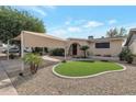 Single story home with carport and artificial turf at 4121 W Medlock Dr, Phoenix, AZ 85019