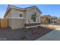 Single story home with neutral exterior and small front yard at 21033 E Camina Buena Vis, Queen Creek, AZ 85142
