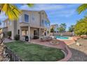 Large backyard with sparkling pool, patio furniture, and lush lawn at 5542 E Anderson Dr, Scottsdale, AZ 85254