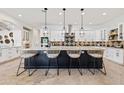 Modern kitchen with large island and stylish bar stools at 8575 E Sharon Dr, Scottsdale, AZ 85260