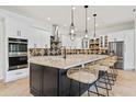 Modern kitchen with large island, stainless steel appliances, and stylish backsplash at 8575 E Sharon Dr, Scottsdale, AZ 85260