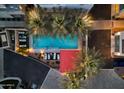 Aerial view of community pool with palm trees and lounge chairs at 3510 N Miller Rd # 1014, Scottsdale, AZ 85251