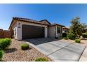 House exterior with brown garage door and driveway at 18767 W Canterbury Dr, Surprise, AZ 85388