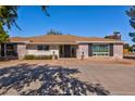 Brick ranch style home with long driveway and mature trees at 966 E Desert Ln, Gilbert, AZ 85234