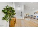 Light and airy entryway with wood floors and a view into the living room at 13789 E Geronimo Rd, Scottsdale, AZ 85259