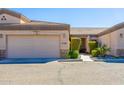 Tan two-car garage with front entry and landscaping at 846 N Pueblo Dr # 110, Casa Grande, AZ 85122