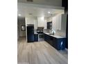 Modern kitchen with white and dark blue cabinets and stainless steel appliances at 1702 E Bell Rd # 106, Phoenix, AZ 85022