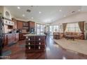 Spacious kitchen with island, granite countertops, and dark wood cabinets at 4124 W Lydia Ln, Phoenix, AZ 85041