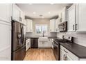 Modern kitchen with white shaker cabinets and stainless steel appliances at 3942 E Cat Balue Dr, Phoenix, AZ 85050