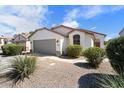 Single story house with attached garage and landscaping at 38169 N Rusty Ln, San Tan Valley, AZ 85140