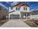 Two-story home with gray siding, red accents, and a landscaped front yard at 17978 W Long Lake Rd, Goodyear, AZ 85338