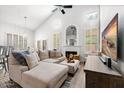 Spacious living room featuring a sectional sofa, fireplace, and large TV at 9056 E Maple Dr, Scottsdale, AZ 85255
