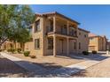 Two-story house with balcony and landscaped front yard at 913 E Agua Fria Ln, Avondale, AZ 85323
