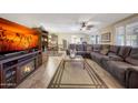 Living room with sectional sofa and built-in fireplace at 9901 W Kingswood Cir, Sun City, AZ 85351