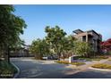 Modern apartment building entrance with landscaped grounds at 19360 N 73Rd St # 1065, Scottsdale, AZ 85255