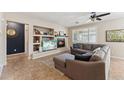 Spacious living room with a fireplace and built-in shelving at 14588 W Laurel Ln, Surprise, AZ 85379