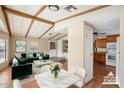 Virtually staged dining area with modern furniture and adjacent kitchen at 9302 E Broadway Rd # 42, Mesa, AZ 85208