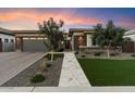 Modern home exterior with a landscaped yard and walkway at 9622 W Villa Chula Dr, Peoria, AZ 85383