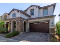 Two-story home with stone accents and a three-car garage at 10523 E Simone Ave, Mesa, AZ 85212