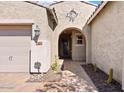 House exterior with a decorative metal door and walkway at 11856 W Lone Tree Trl, Peoria, AZ 85383