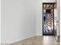 Front entry with tile flooring and a decorative metal door at 11856 W Lone Tree Trl, Peoria, AZ 85383
