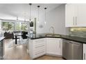 Modern kitchen with white cabinets, stainless steel appliances, and a large island at 7700 E Gainey Ranch Rd # 206, Scottsdale, AZ 85258