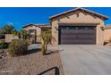 Single-story home with a two-car garage and desert landscaping at 744 E Laddoos Ave, Queen Creek, AZ 85140