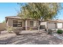 One-story house with tan exterior, stone accents, and a two-car garage at 2268 S 162Nd Ln, Goodyear, AZ 85338