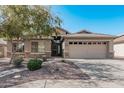 One-story house with tan exterior, stone accents, and a two-car garage at 2268 S 162Nd Ln, Goodyear, AZ 85338