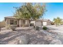One-story house with tan exterior, stone accents, and a two-car garage at 2268 S 162Nd Ln, Goodyear, AZ 85338