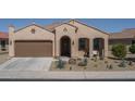 Single-story home with a two-car garage and desert landscaping at 26404 W Zachary Dr, Buckeye, AZ 85396