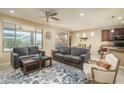 Spacious living room with gray sofas and a coffee table at 26404 W Zachary Dr, Buckeye, AZ 85396