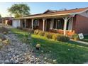 Ranch home with a covered porch and well-maintained lawn at 3614 W Krall St, Phoenix, AZ 85019