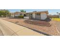 House exterior with a two-car garage and nicely landscaped yard at 4419 W Vogel Ave, Glendale, AZ 85302