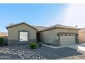 Single-story house with a two-car garage and desert landscaping at 13585 W Ironwood St, Surprise, AZ 85374