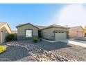 Single-story home with attached garage and rock landscaping at 13585 W Ironwood St, Surprise, AZ 85374