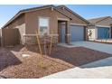 Single-story home with gray garage door and desert landscaping at 17431 W Sanna St, Waddell, AZ 85355