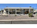 Single-wide manufactured home with covered porch and well-maintained landscaping at 2400 E Baseline Ave # 301, Apache Junction, AZ 85119