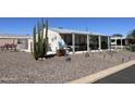 Single-wide manufactured home with covered porch, cacti, and rock landscaping at 2400 E Baseline Ave # 301, Apache Junction, AZ 85119