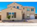 Two-story house with beige exterior, brown shutters, and a two-car garage at 8823 W Wagon Wheel Dr, Glendale, AZ 85305