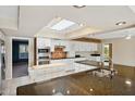 Modern kitchen with granite island, stainless steel appliances, and skylights at 12423 W Rock Springs Dr, Sun City West, AZ 85375