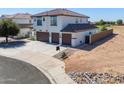 Two-story home with a three-car garage and landscaped yard at 20358 N Valencia N Dr, Maricopa, AZ 85138